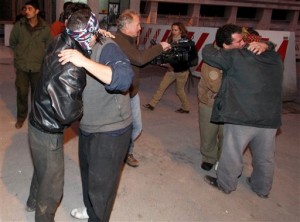 Freed Syrian prisoners are hugged by their relatives. [AP]