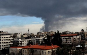 Smoke rises from a building struck by artillery in north Damascus [Xinhua]