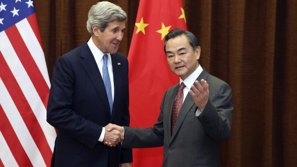 Kerry, seen here with with Chinese Foreign Minister Wang Yi in 2013, is likely to press the issue of South China Sea access [Xinhua]