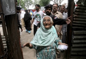 An elderly woman casting her ballot in Lahore (AP Images)