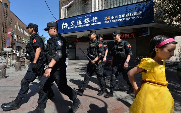 File photo of Chinese security personnel patrolling the restive region of Xinjiang [Getty Images]