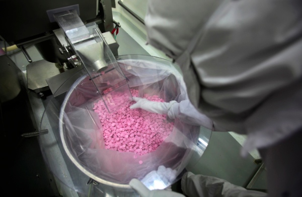 A chemist is seen working in a lab where medicines are being produced at a Cipla manufacturing unit on the outskirts of Mumbai, India, Thursday, Feb 9, 2012 [AP]