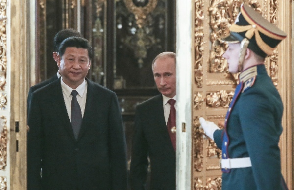 Vladimir Putin rolled out a grandiose reception Friday for China's new president, who has chosen Moscow as his first foreign destination in March 2013 [AP]
