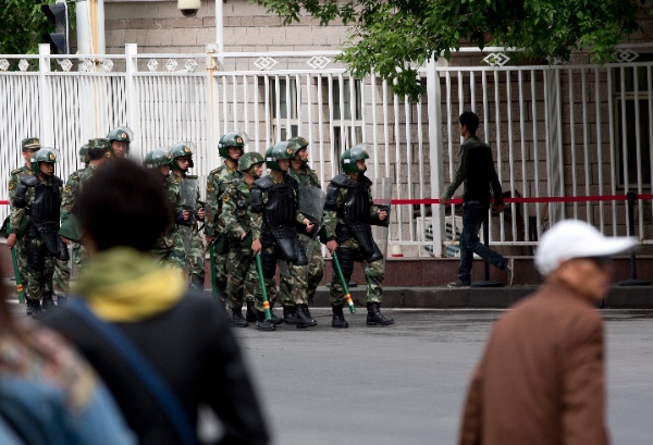 In this May 23, 2014 photo, armed paramilitary policemen patrol on a street in Urumqi, northwest China's Xinjiang Uygur Autonomous Region [AP]