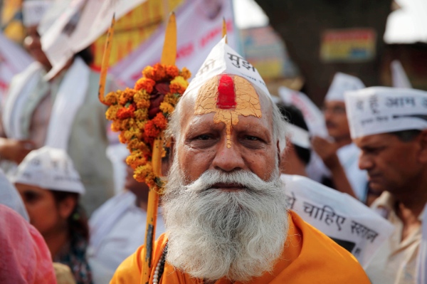 A Sadhu, or Hindu holy man, wears a cap in support of the Aam Aadmi Party (AAP), or the common man party, and participates in an election rally of AAP leader Arvind Kejriwal in Varanasi, in the northern Indian state of Uttar Pradesh, Friday, May 9, 2014 [AP]