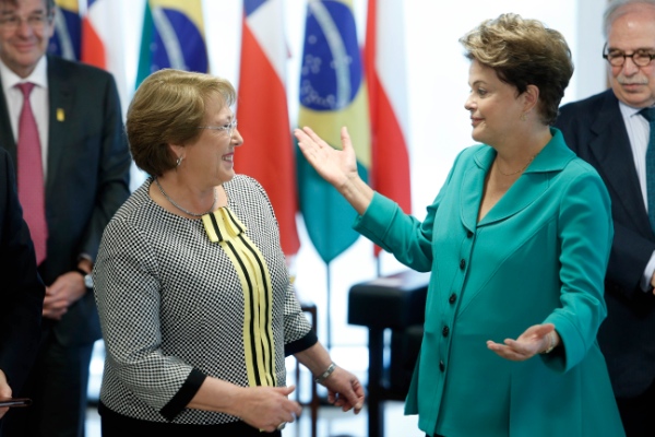 Brazil's President Dilma Rousseff, right, talks with Chile's President Michelle Bachelet at the Planalto presidential palace, in Brasilia, Brazil, Thursday, June 12, 2014 [AP]