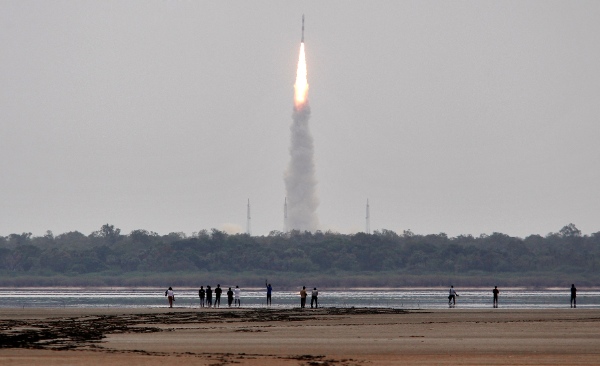 Indians watch the Polar Satellite Launch Vehicle (PSLV-C23) rocket lifting off from the east coast island of Sriharikota, India, Monday, June 30, 2014. The rocket was carrying French Earth Observation Satellite SPOT-7 with four other satellites, AISAT of Germany, NLS7.1 (CAN-X4) and NSL7.2 (CAN-X5) of Canada and VELOX-1 of Singapore [AP]