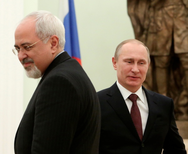 Russian President Vladimir Putin, right, passes by Iranian Foreign Minister Mohammad Javad Zarif during their meeting in the Kremlin in Moscow, Russia, Thursday, Jan. 16, 2014 [AP]