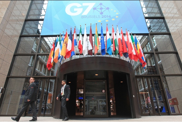 Two security guards pass the entrance of the European Council building in Brussels ahead of a two-day G7 meeting, Wednesday, June 4, 2014 [AP]