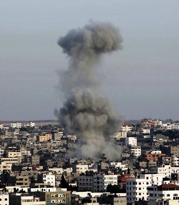 Smoke rises following an Israeli strike on Gaza Strip, Saturday, July 12, 2014. Israeli airstrikes on Gaza hit a mosque and a center for the disabled where two women were killed Saturday [AP]