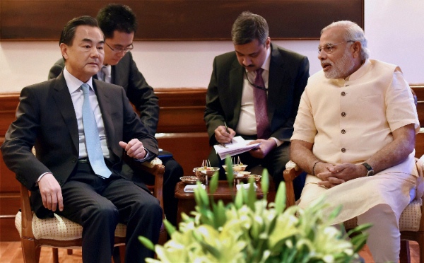 In this Monday, June 9, 2014 file photo, visiting Chinese Foreign Minister Wang Yi, left, sits with Indian Prime Minister Narendra Modi, right during their meeting in New Delhi, India [AP]