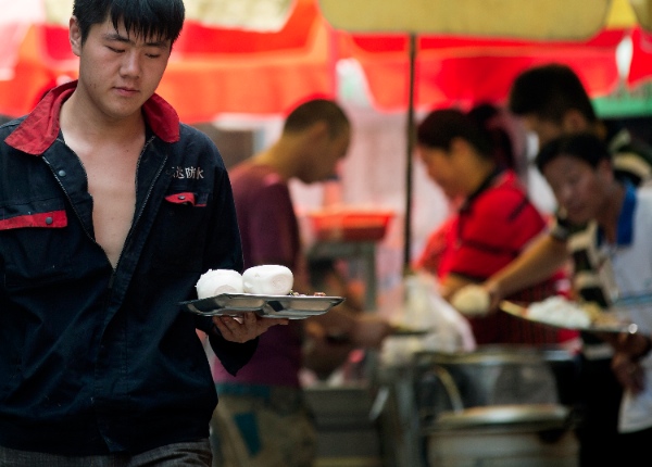 Chinese people buy their meals during their lunch break in Beijing, China Tuesday, June 10, 2014 [AP]