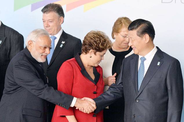 Chinese President Xi Jinping (extreme right) shake hands with Indian Prime Minister Narendra Modi before the family photo of the BRICS-UNASUR Summit in Brazil on July 16 2014 [gov.br]