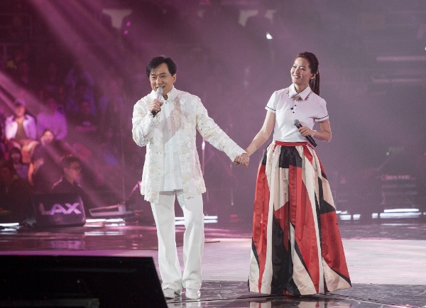 Action movie actor Jackie Chan (L) and singer Joi Chua sing at a charity concert marking Jackie Chan's 60th birthday in Beijing, capital of China, April 6, 2014 [Xinhua]