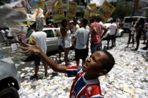 A boy plays with campaign flyers during the general elections in Salvador de Bahia, Brazil, on Oct. 5, 2014 [Xinhua]
