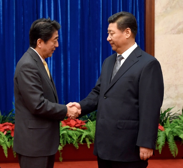 File photo: Chinese President Xi Jinping (R) and Japanese Prime Minister Shinzo Abe hold a meeting at the request of the Japanese side ahead of the 22nd Asia-Pacific Economic Cooperation (APEC) Economic Leaders' Meeting in Beijing, China, Nov. 10, 2014 [Xinhua]