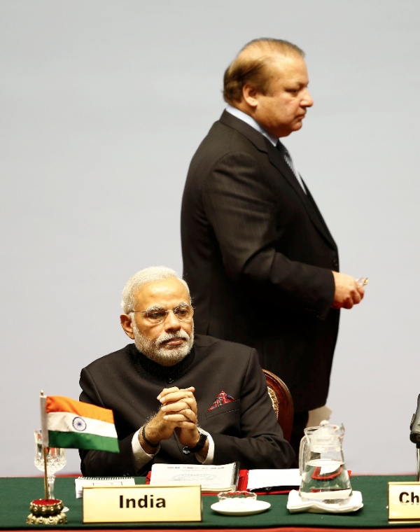 Pakistani Prime Minister Nawaz Sharif walks past Indian Prime Minister Narendra Modi during the opening session of the 18th South Asian Association for Regional Cooperation (SAARC) Summit at City Hall in Kathmandu, Nepal, Nov. 26, 2014 [Xinhua]