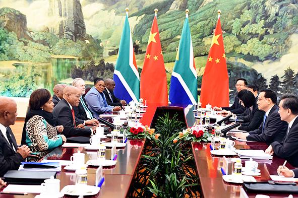 flanked by seven South African Ministers, including Finance Minister Nhlanhla Nene, Foreign Minister Maite Nkoana-Mashabane and Trade Minister Rob Davies met members of the Chinese Cabinet headed by Premier Li Keqiang in Beijing on 4 December 2014 [GCIS]
