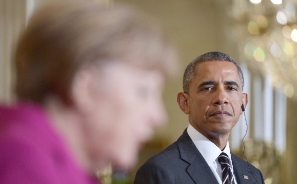 U.S. President Barack Obama (R) listens as German Chancellor Angela Merkel speaks during their joint news conference in the East Room of the White House in Washington D.C., the United States, Feb. 9, 2015 [Xinhua]