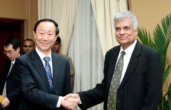 Sri Lankan Prime Minister Ranil Wickremesinghe (R) shakes hands with Wang Jiarui, vice chairman of the National Committee of the Chinese People's Political Consultative Conference, in Colombo, Sri Lanka, Feb. 12, 2015 [Xinhua]