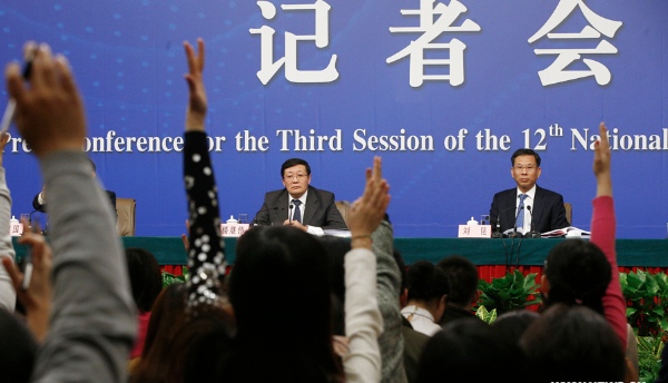 Chinese finance minister Lou Jiwei (back L) and vice finance minister Liu Kun (backR) give a press conference for the third session of China's 12th National People's Congress (NPC) on fiscal and tax reform, in Beijing, capital of China, March 6, 2015 [Xinhua]