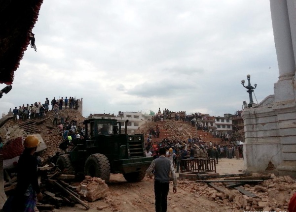 People gather around a collapsed building after an earthquake in Durbar square in Kathmandu, capital of Nepal, on April 25, 2015 [Xinhua]