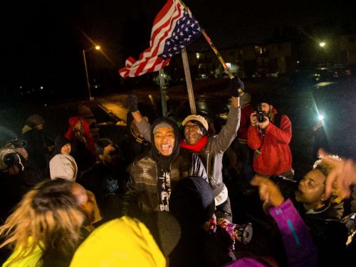 Protesters protest on the street in Ferguson, Missouri, the United States, on Nov. 23, 2014, pending the Grand Jury’s decision on whether to charge the police officer killing unarmed 18-year-old Michael Brown on August 9 2014 [Xinhua]