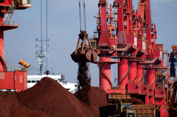 Ships unload iron ore at the ore terminal at Rizhao Port in Shandong province of China in this file photograph [Xinhua]