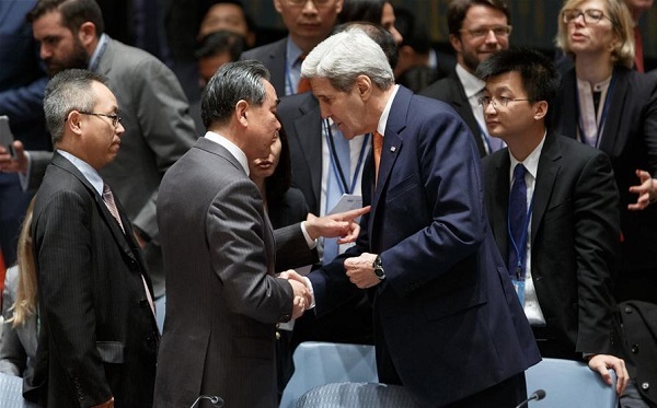 Chinese Foreign Minister Wang Yi (2nd L) talks with United States Secretary of State John Kerry prior to the United Nations Security Council meeting on Syria at the UN headquarters in New York, Dec. 18, 2015 [Xinhua]