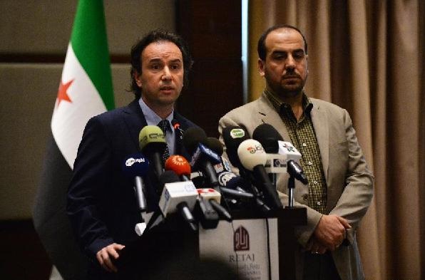 president of Syria's main opposition National Coalition Khaled Khoja(L) delivers a speech at the press conference in Istanbul, Turkey, on Jan. 5, 2015 [Xinhua]