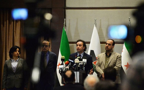File photo:  president of Syria's main opposition National Coalition Khaled Khoja(2nd R) [Xinhua]