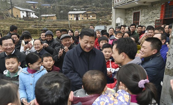 Chinese President Xi Jinping, also general secretary of the Communist Party of China (CPC) Central Committee and chairman of the Central Military Commission, extends holiday greetings to villagers while visiting Shenshan Village in Jinggangshan, east China's Jiangxi Province, Feb. 2, 2016 [Xinhua]