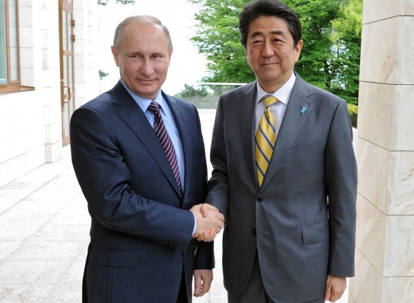 Although Abe, right, made progress in talks with Rosneft, the issue of the Kuril islands is to be discussed in June [Xinhua]