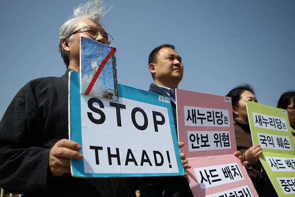South Korean protesters hold placards during a rally against the deployment of the advanced U.S. missile defense system on the Korean Peninsula, called Terminal High-Altitude Area Defense (THAAD), in front of the National Assembly in Seoul, South Korea, April 1, 2015 [Xinhua]